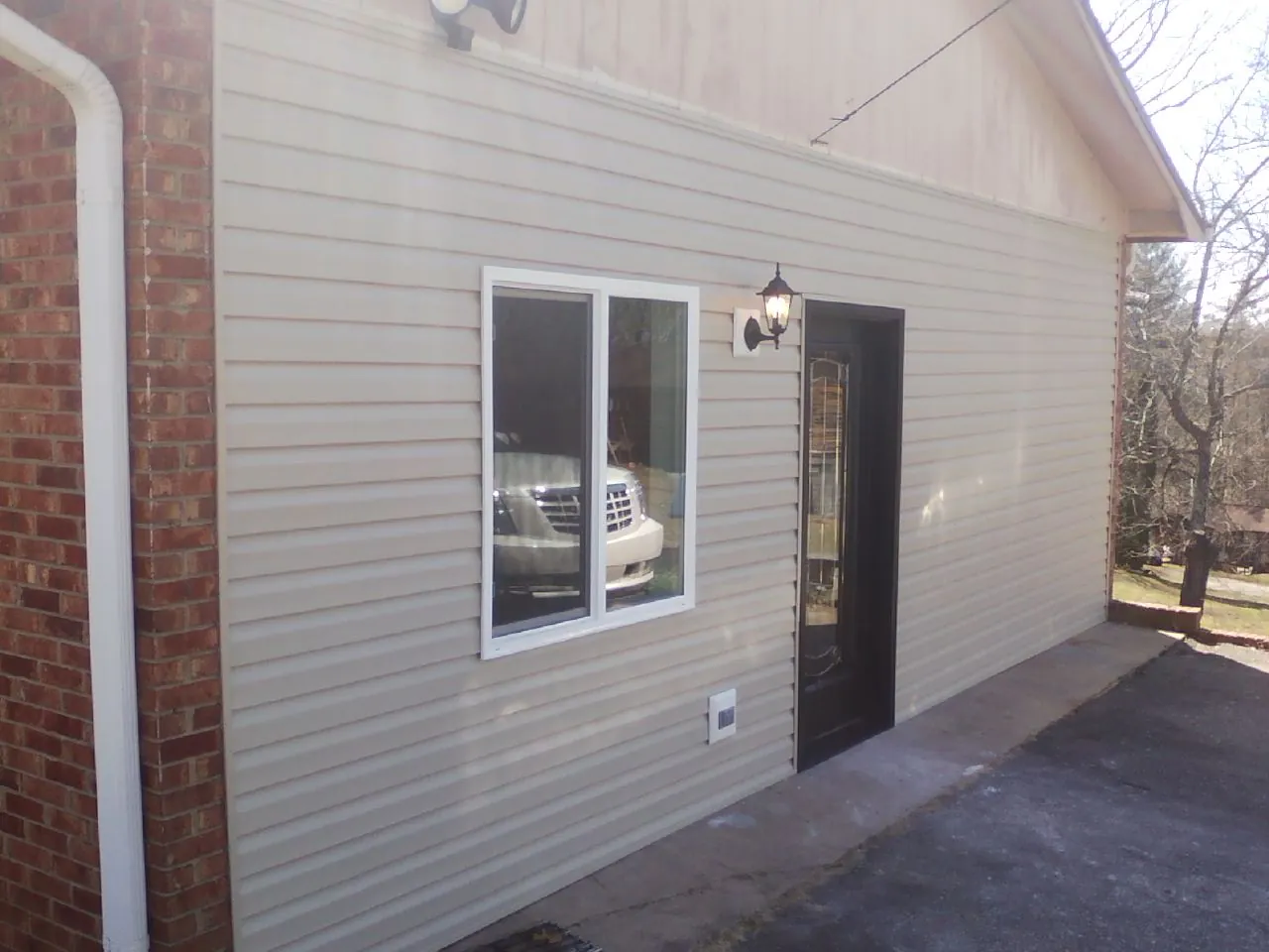 New vinyl siding and entry door on a room addition in Milledgeville